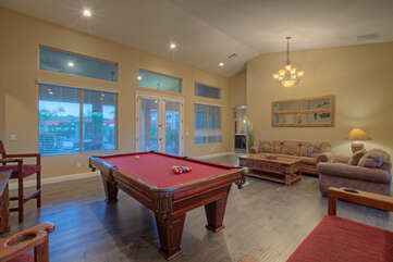 Demonstrate your best cue action at the pool table in the game room.