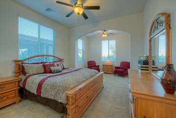 A king bed, sitting area and ceiling fan are appealing features of the casita's bedroom.