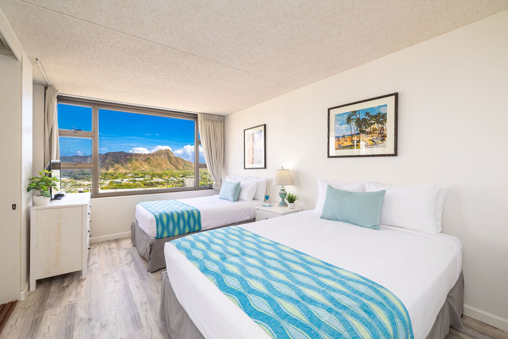 Bedroom with 1 queen size bed and 1 full size bed and Ocean and Diamond Head views from your window!