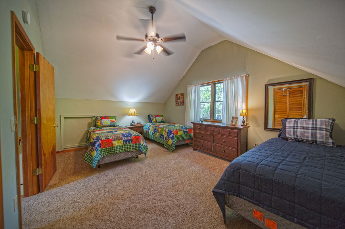 Upper level bedroom with three twin beds