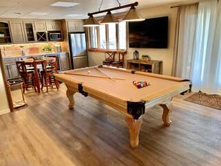 Room with pool table and nearby seating