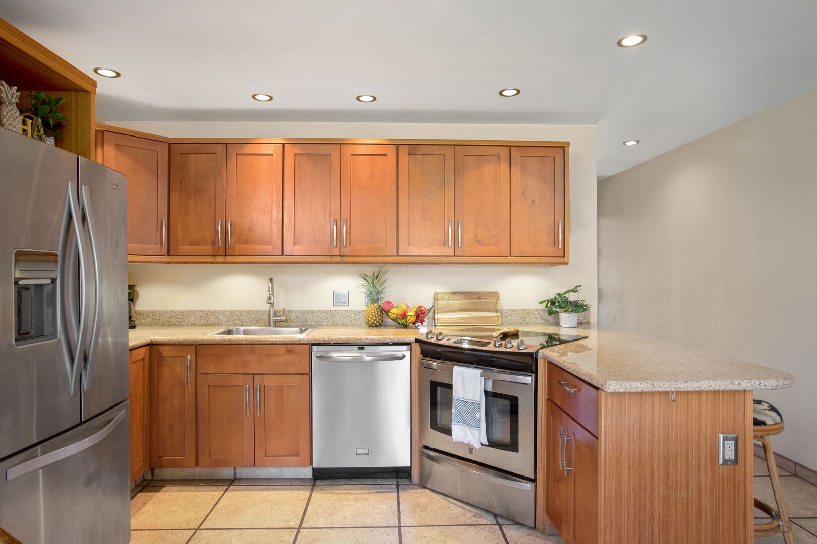 Fully-equipped kitchen with refrigerator, dishwasher, stove, oven, and microwave