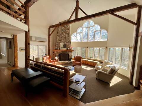 Great room with big nature views and a giant stone fireplace