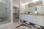 Master bath with fully tiled walk-in shower and large walk-in closet