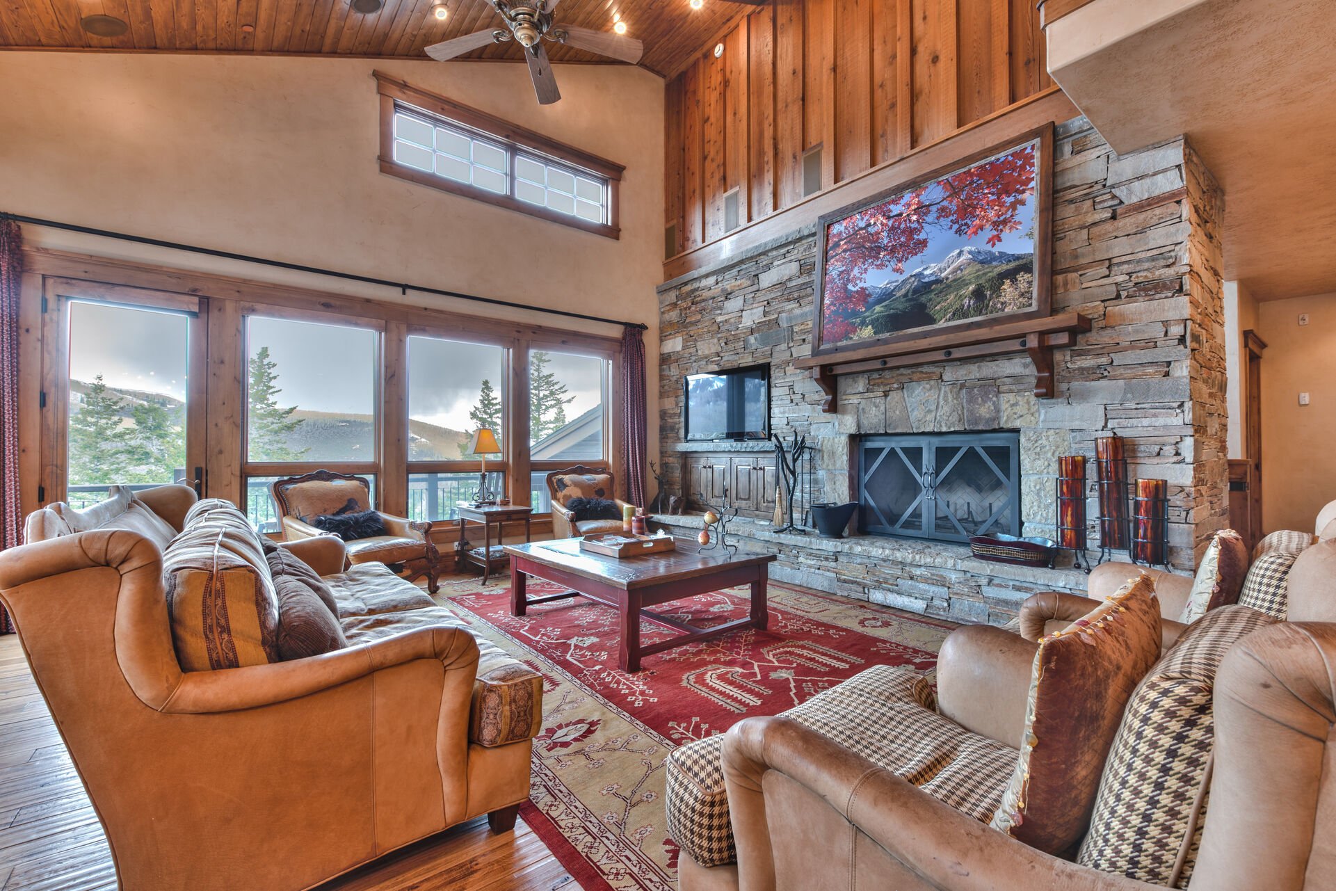 Spacious Living Room with Mountain Furnishings, a Wood Burning Fireplace, 50'' HDTV, Hardwood Flooring, and Mountain Views