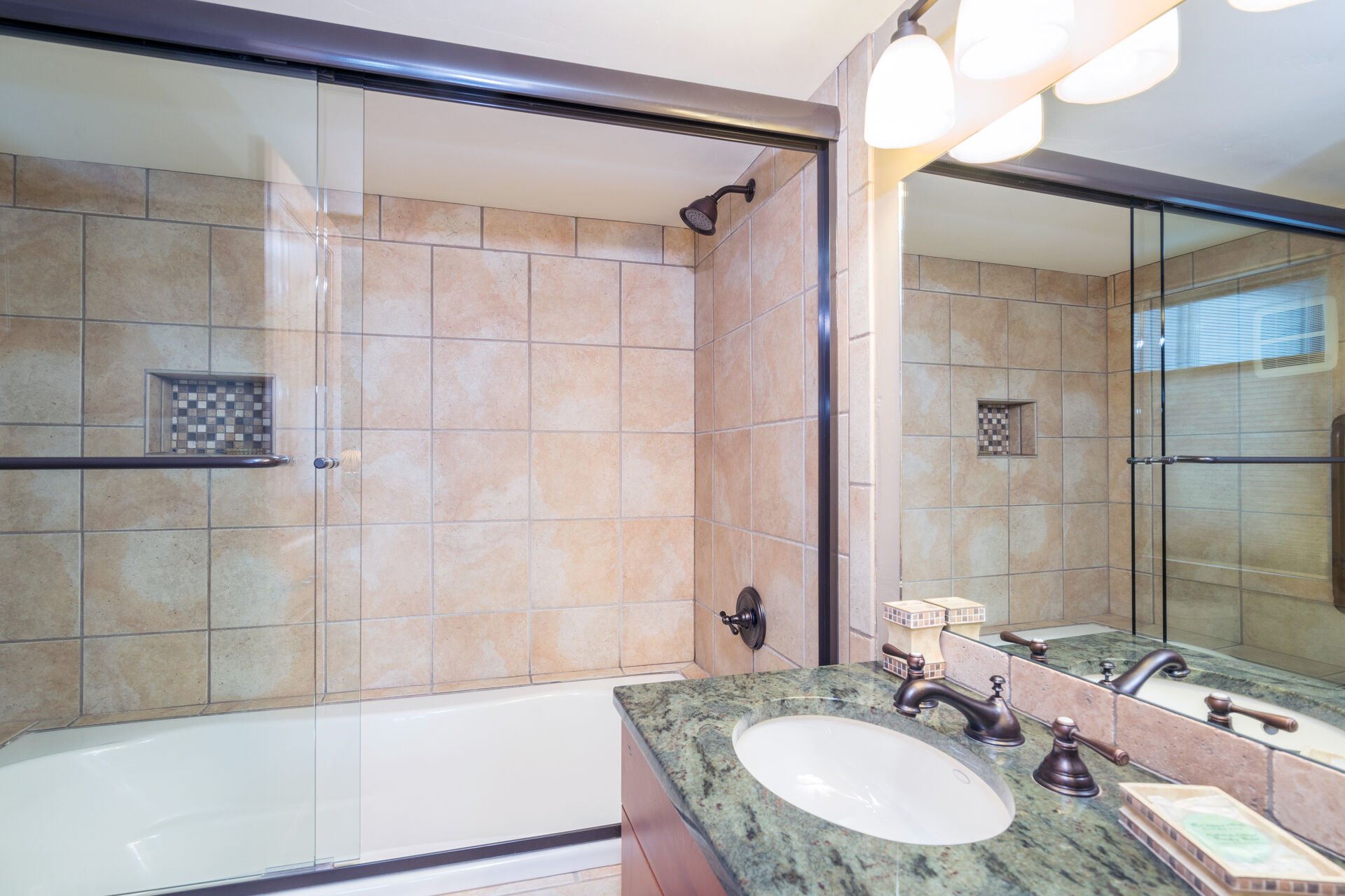 Bathroom with glass-door shower and vanity sink.