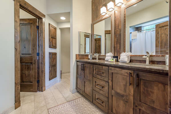 Master Bath with Double Vanity Sinks, Water Closet, and Tile Floors