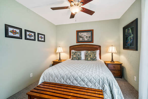 Bedroom with ceiling fan and nightstands.