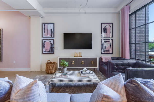 Living Area Includes Large TV and Chic Furnishings.