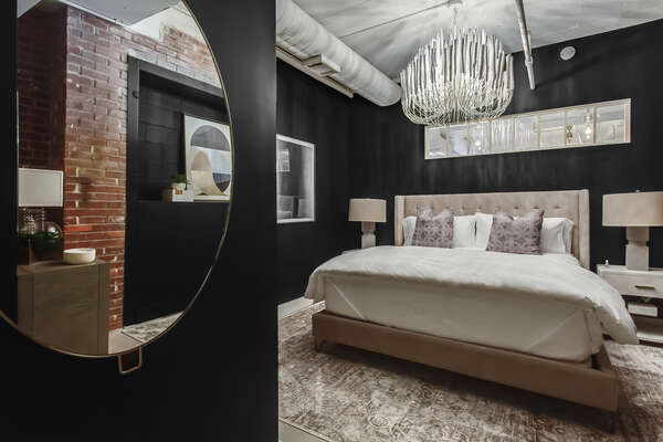 Luxury Bedroom Features Black Walls and Beautiful Furnishings.