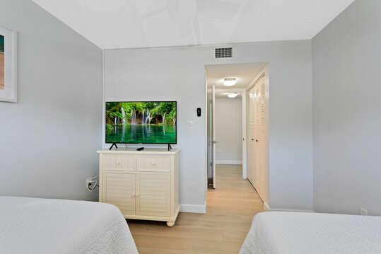 Guest bedroom includes a TV.