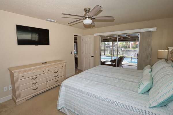 Master bedroom, large scree TV, and access to lanai
