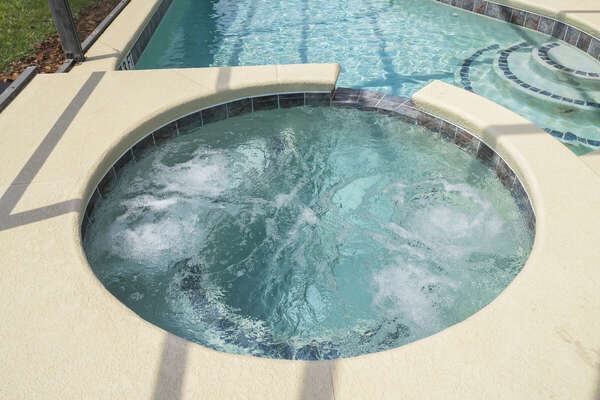 Bubbling spa with waterfall spillover. Add spa heating for  extra relaxation.