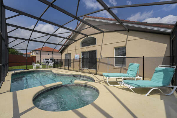 Spa and pool showing the pool enclosure showing 2 sun loungers and pool safety fence