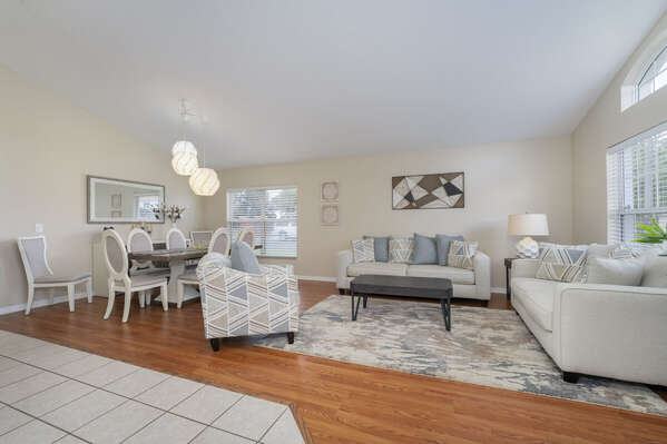 Family room located at entry showing sofa seating, accent chair, and dining table
