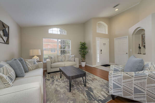 Family room located at entry showing sofa seating, accent chair,