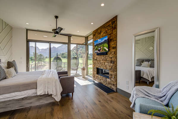 Master Bedroom with a King Bed, Stone Wall with a Gas Fireplace and 55