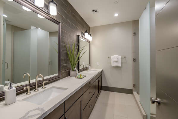 Full Shared Bath with Dual Quartz Countertop Sinks and Tile Shower