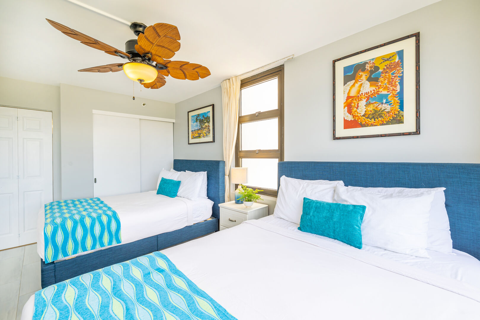 The bedroom has a queen-size bed, 1 full-size bed, and ceiling fan!
