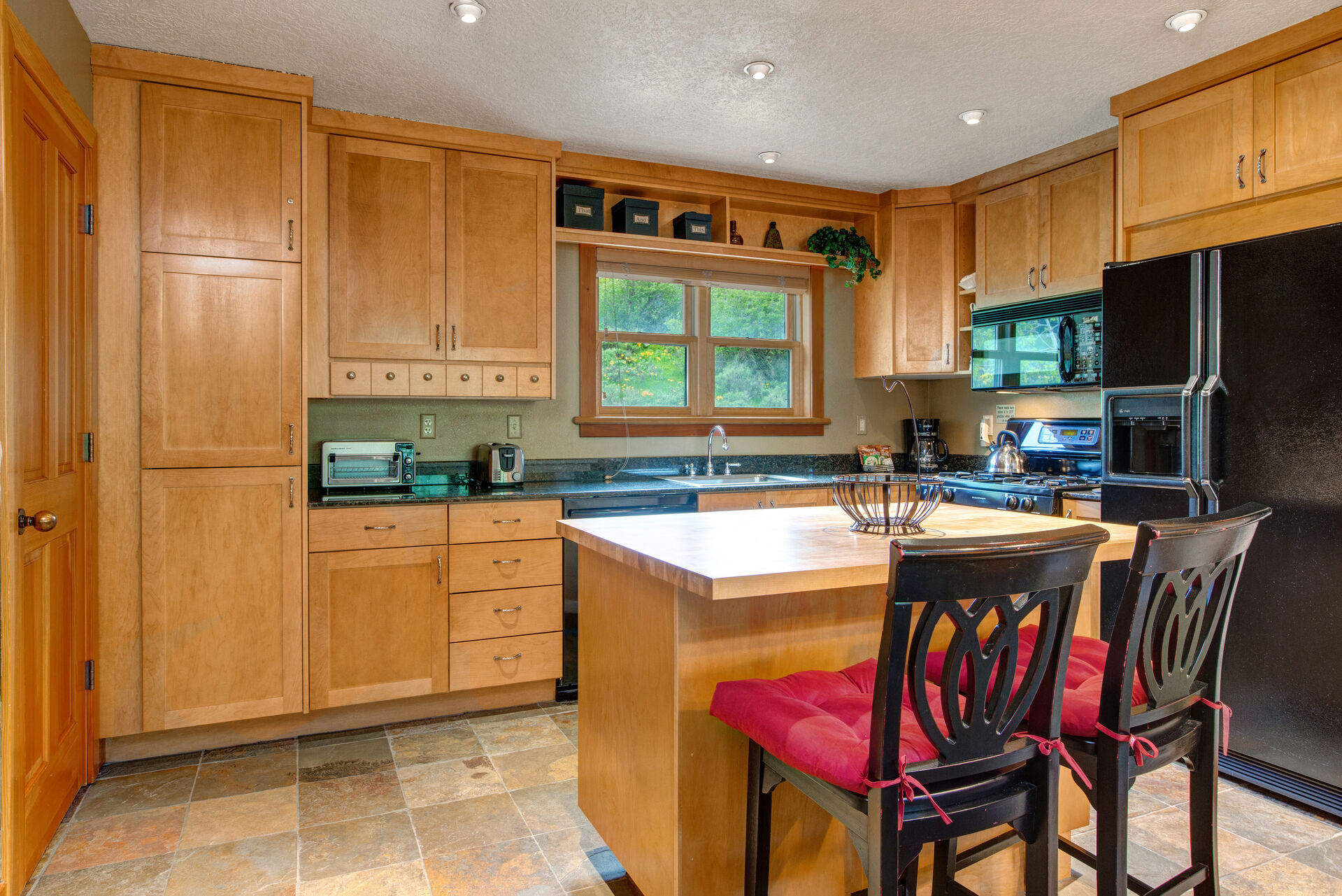 Off the Kitchen to the Left is a Stacked Washer / Dryer and a Half Bath