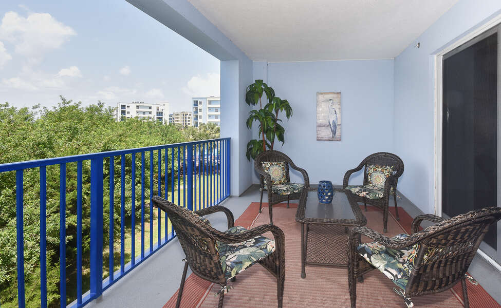 Balcony with outdoor chairs and table in our Ocean Walk 17-302 property