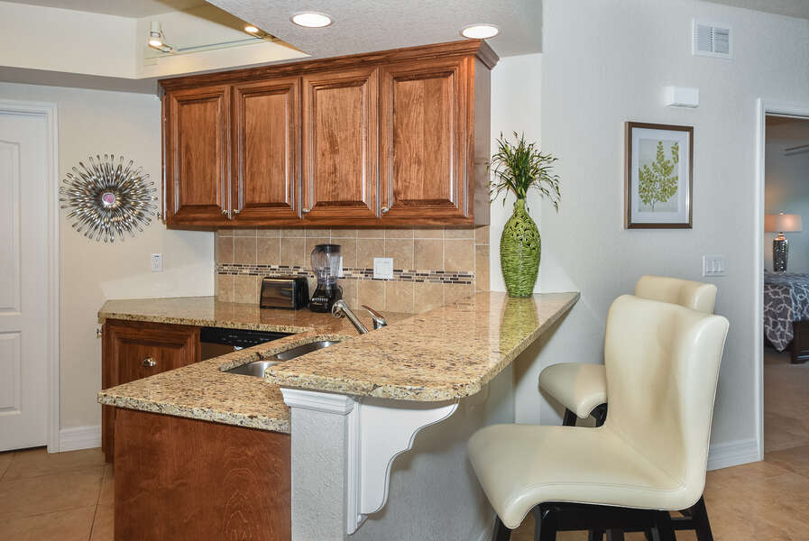 Breakfast Bar with sink and counter stools in our New Smyrna Beach condo rental