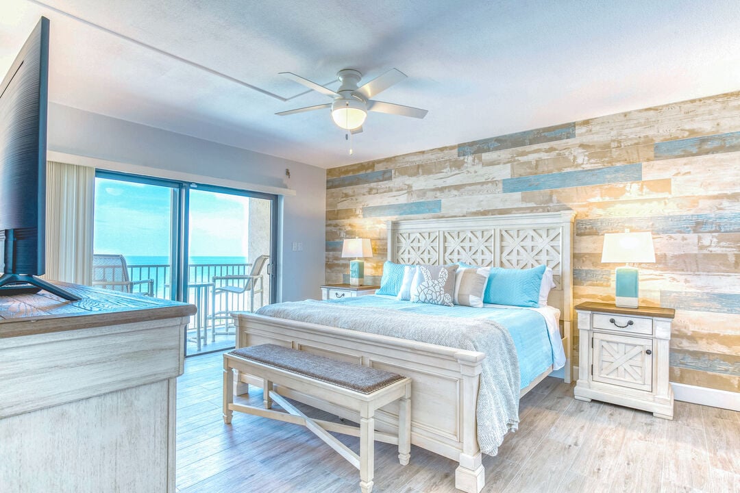 Stylish master bedroom with a wooden accent wall, king-size bed, and warm lighting.