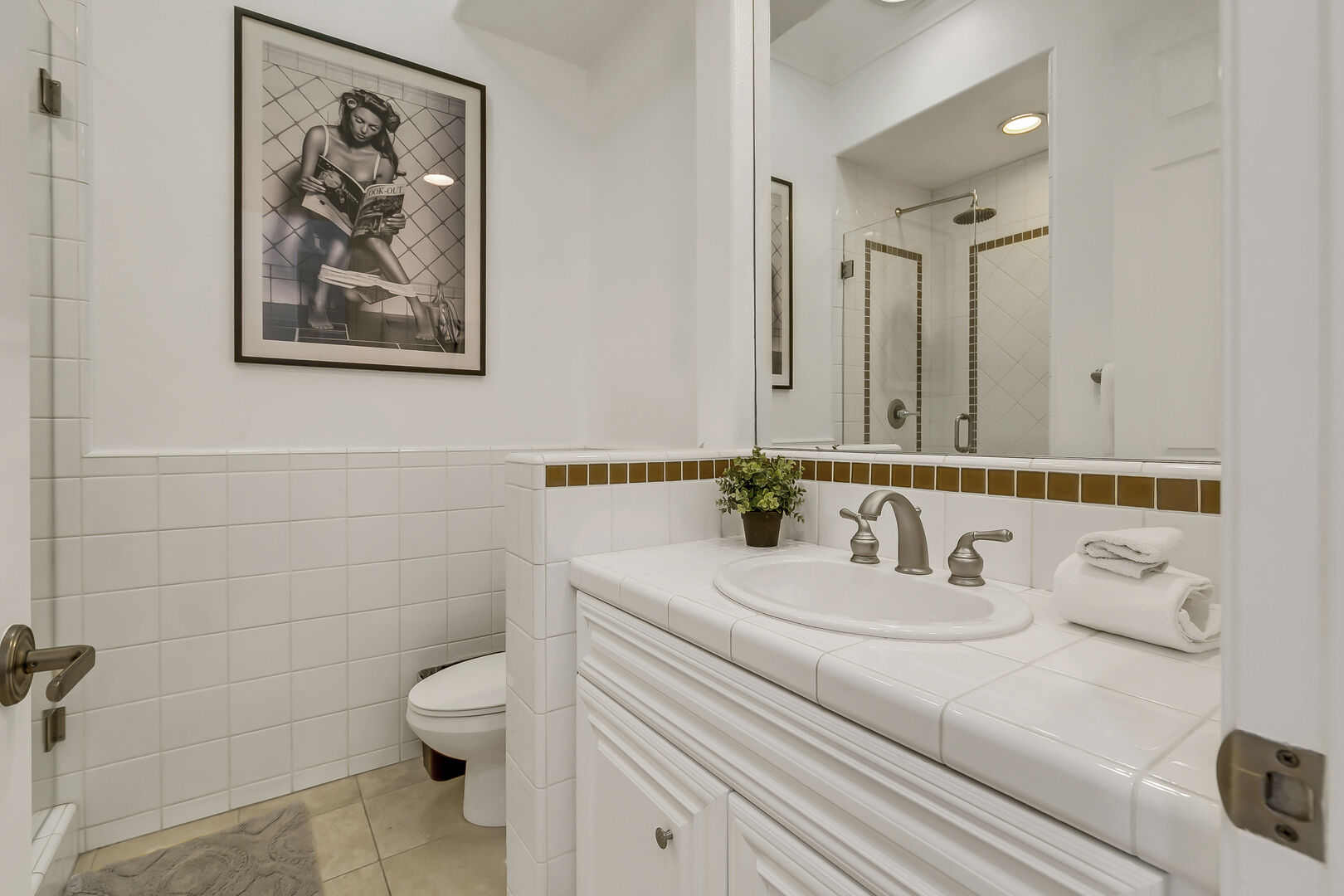 Casita Suite 3's bathroom features a step -in tile shower and vanity sink.
