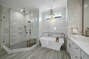 Master bathroom with luxury spa tub, large walk-in shower, and vanity sink.