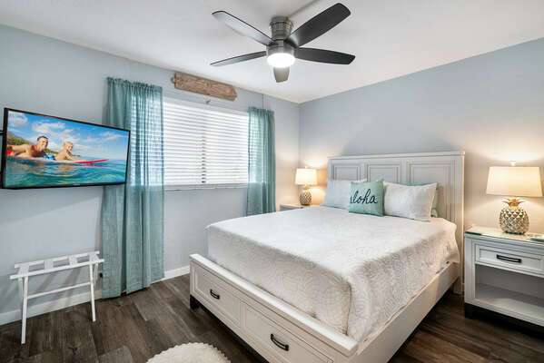 Bedroom with Large Bed, Smart TV, and Ceiling Fan