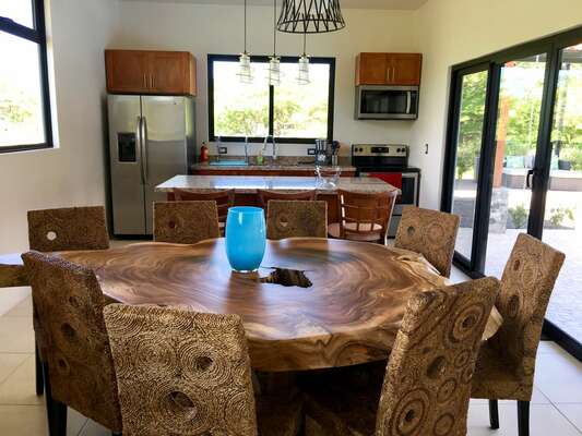 Open kitchen/dining area with custom wood table.