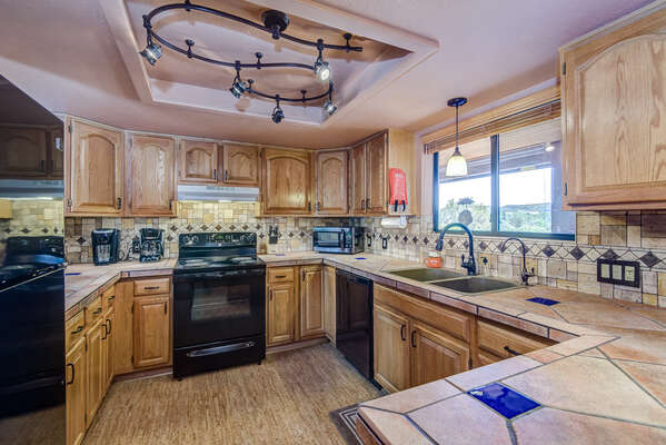 Spacious Fully Equipped Kitchen with Exterior Views and Natural Light
