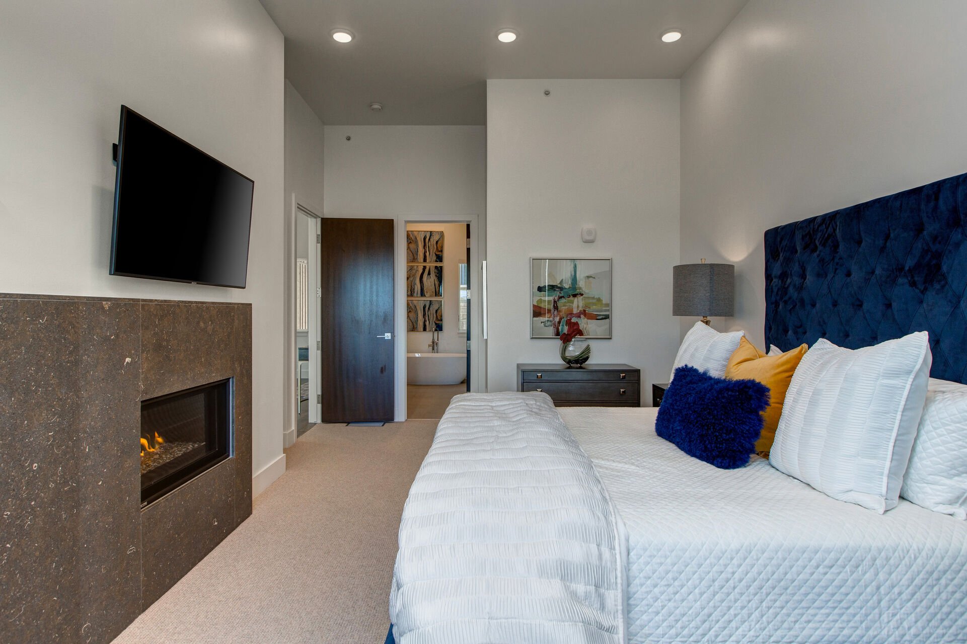 Grand Master Bedroom with a King Bed, Smart TV, and Cozy Gas Fireplace