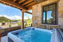 Enjoy a Relaxing Soak in the Private Hot Tub Located on the Back Patio