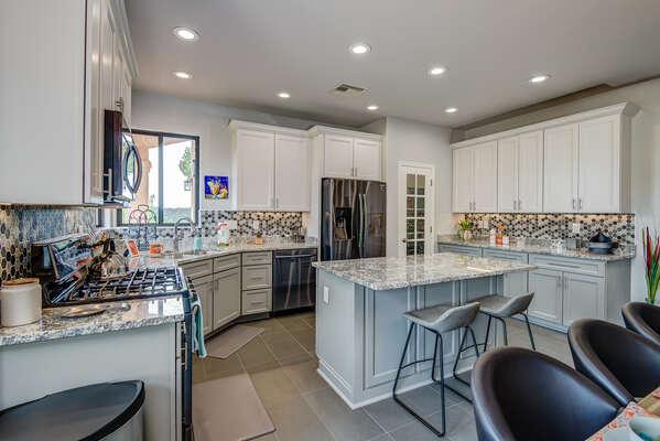 Chef's Kitchen with Dark Stainless Steel Appliances and Granite Counters