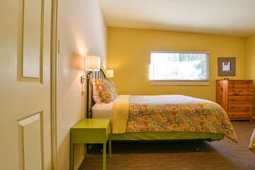 Bedroom with a queen bed and a nightstand