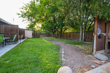 Shared yard features grass and gravel path.