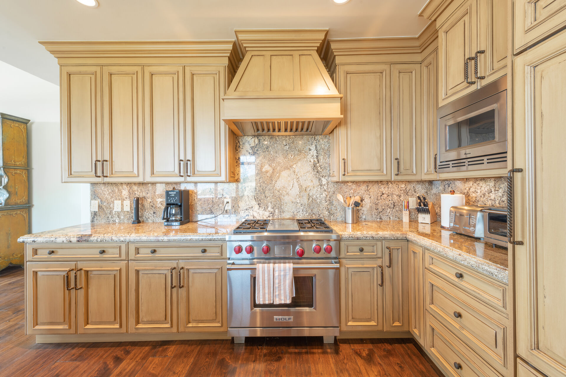Luxury Kitchen with Wolf range, granite tops, and sub Zero fridge.