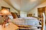 The third bedroom has a king size bed and beautiful custom log furniture.