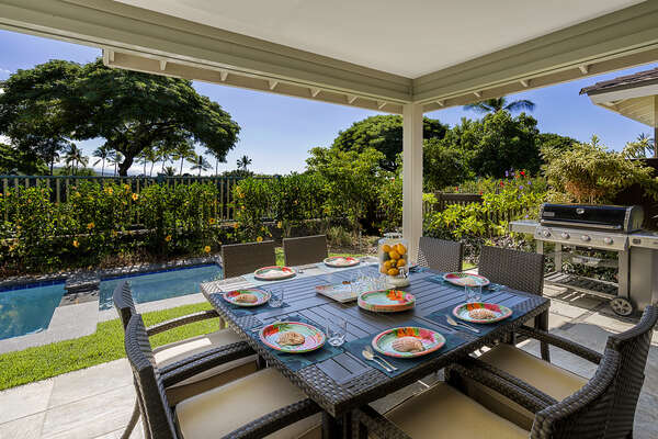 Large outdoor table set for dining on the back lanai.