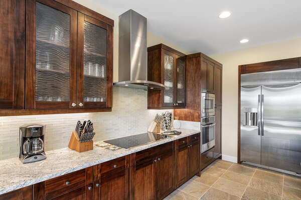 Fully equipped kitchen with large fridge and countertop range.