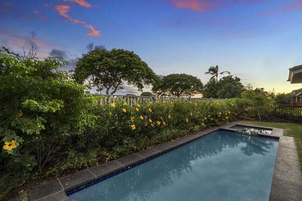 Private pool surrounded by bright tropical landscaping.