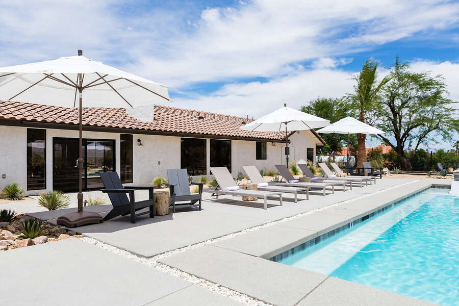 Plenty of space for seating or lounging around the pool. Umbrellas to provide additional shade from the desert summer sun.