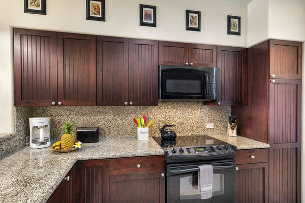 Full Kitchen with Granite Counter Tops and Wooden Cabinets at Waikoloa Hawaii Vacation Rentals