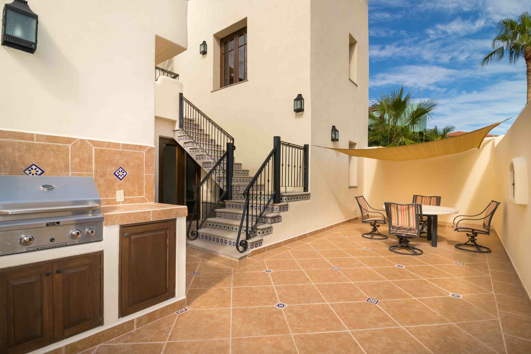 Downstairs Patio, patio furniture and BBQ grill. wider stairs
