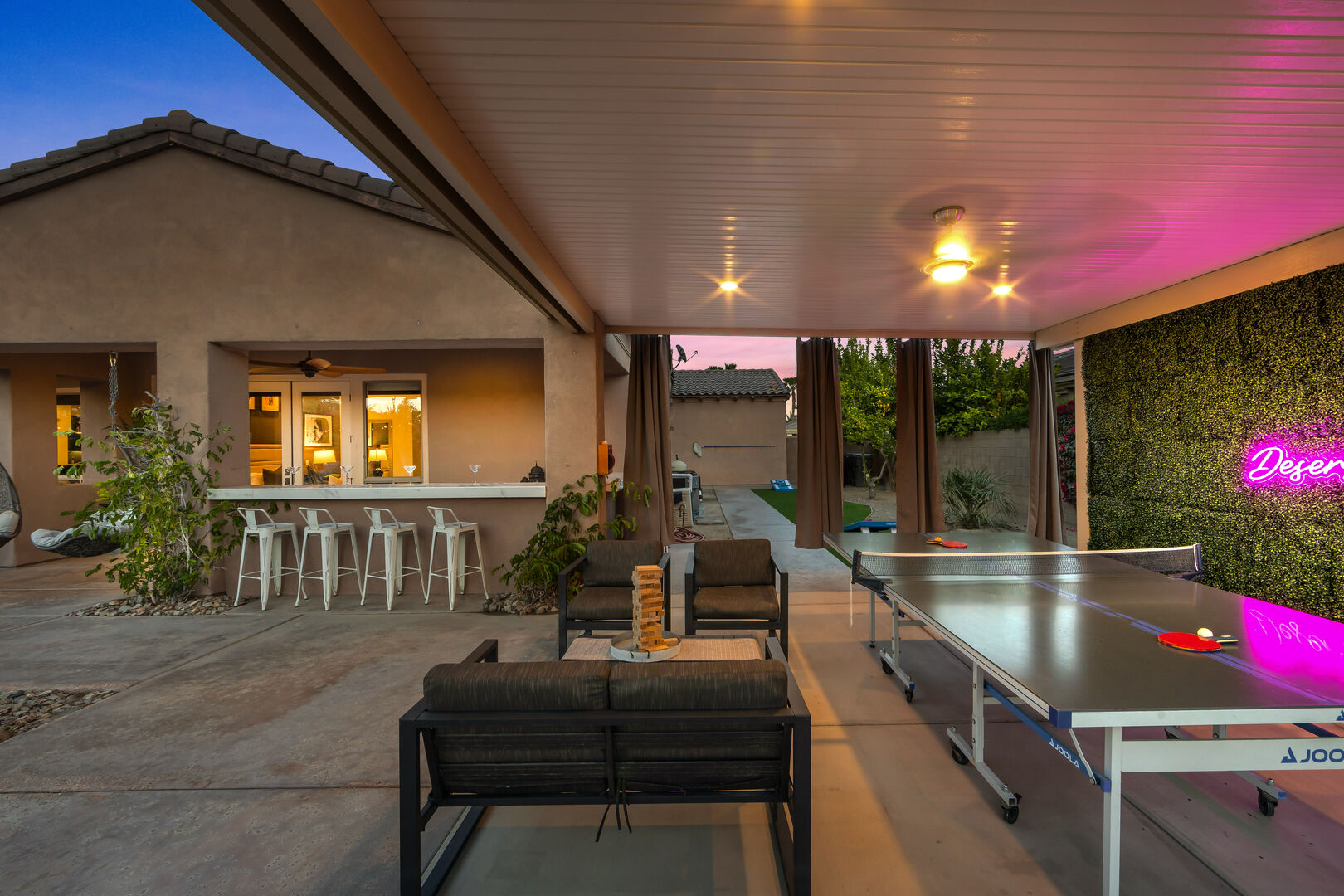 A ping pong table with lighting is available for evening enjoyment. The shaded outdoor space includes additional seating for four!