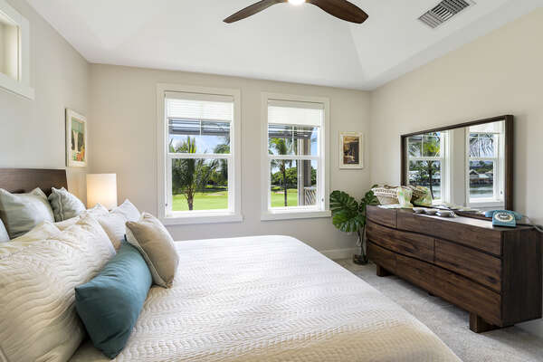 Primary Bedroom With Large Windows and Mirror at Waikoloa Hawai'i Vacation Rentals