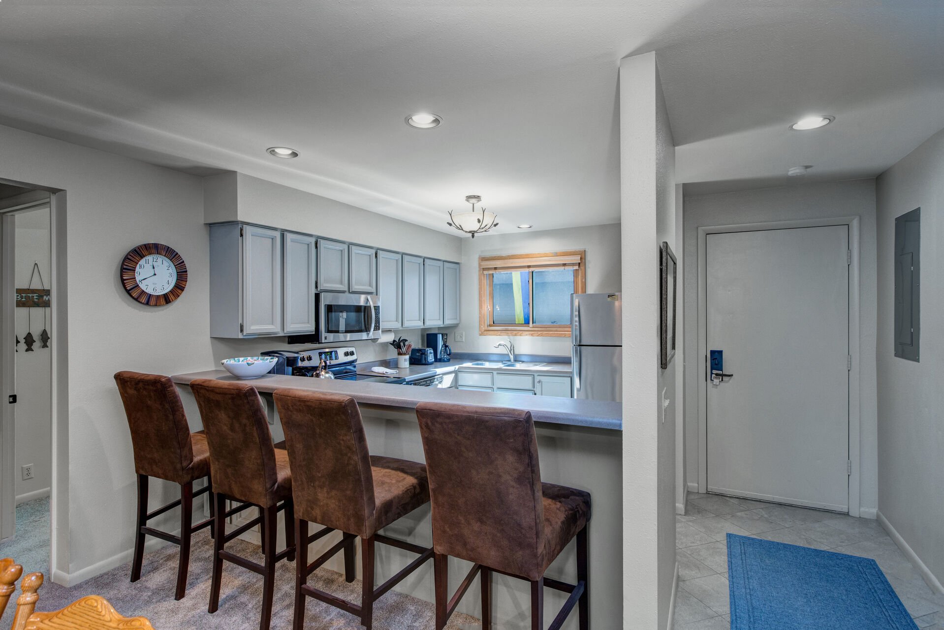 Fully Equipped Kitchen with Stainless Steel Kenmore Appliances, and Convenient Bar Seating for Four