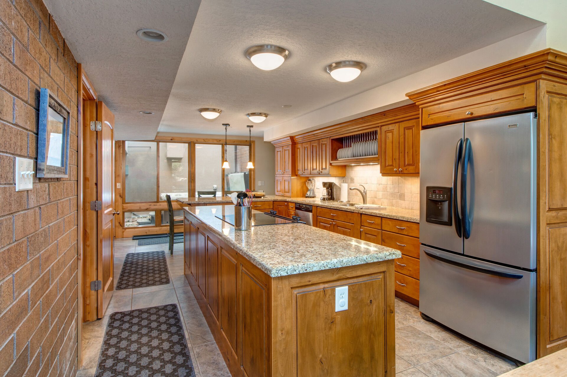 Kitchen Area with a Large Center Island with Electric Range with a Convection Oven