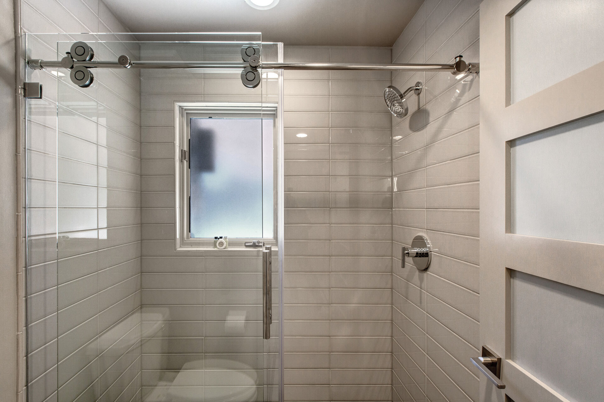 Full Shared Bath with Large Tile Shower with a Sliding Glass Door